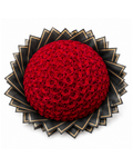 Large bouquet of red roses with a black and gold decorative base on a white background