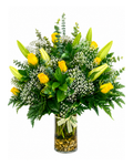 Bouquet of yellow lilies and greenery in a glass vase on a white background