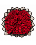 Bouquet of red roses in a decorative black and white box on a white background