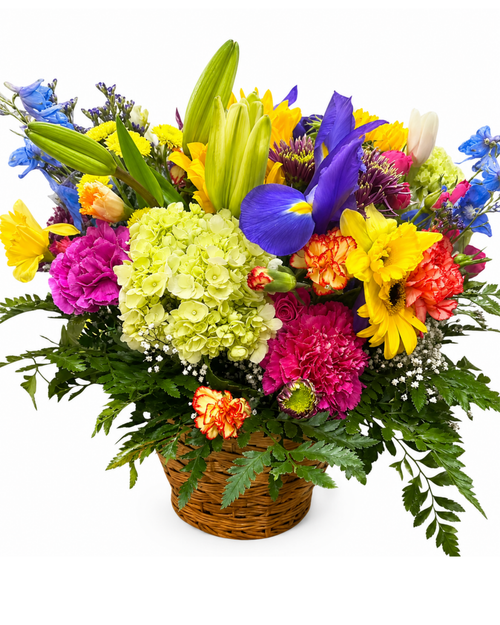 Colorful flower arrangement in a woven basket on a white background