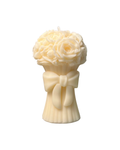 White candle shaped like a bouquet with a bow on a white background