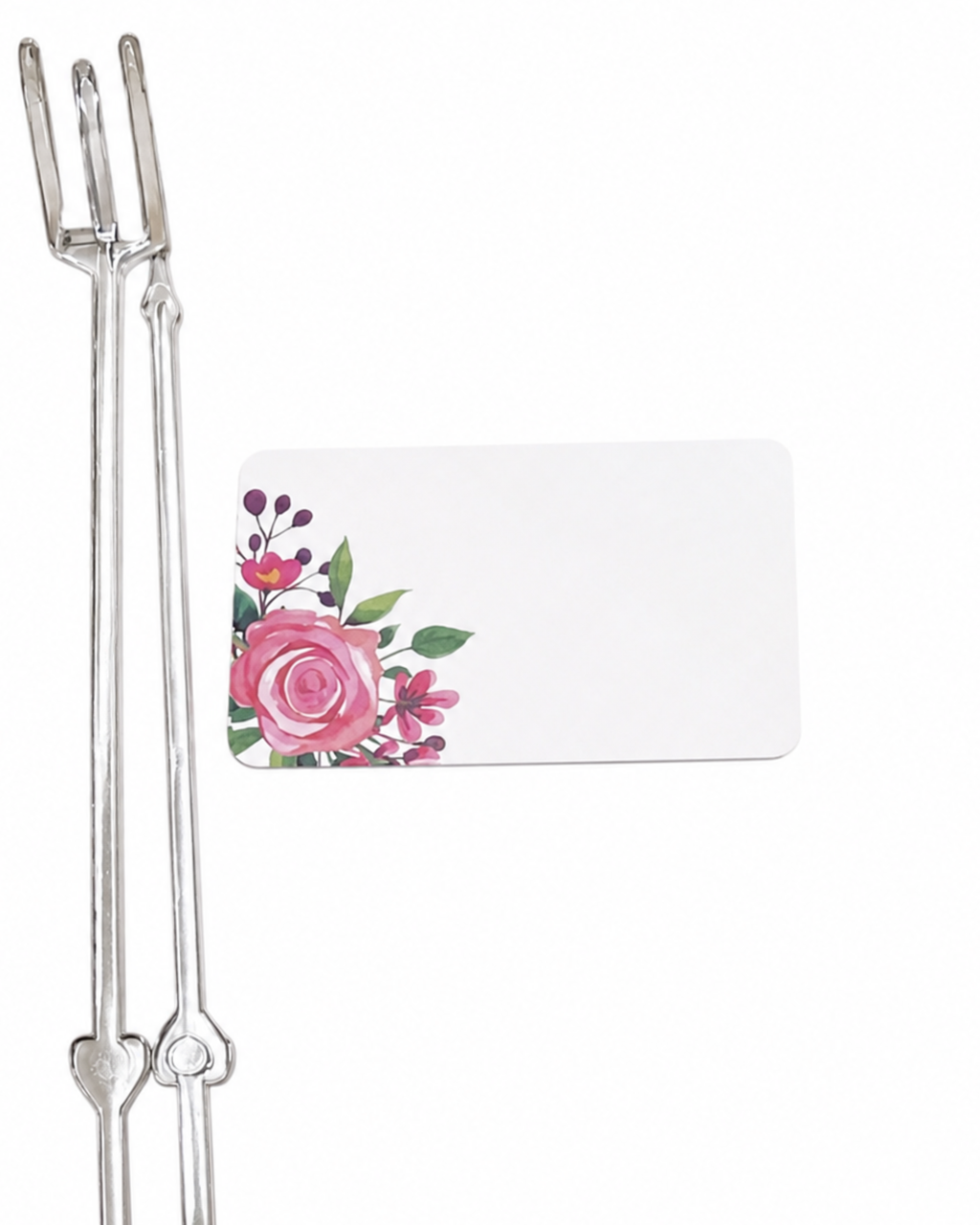 Metallic fork with a floral card on a white background