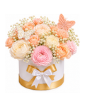 Floral arrangement in a box with a butterfly and white ribbon on a white background