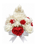 Decorative arrangement with red and white flowers, including roses and a heart-shaped design, on a white background.