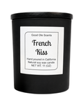 Black candle with a label reading 'French Kiss' by Good Ole Scents on a white background