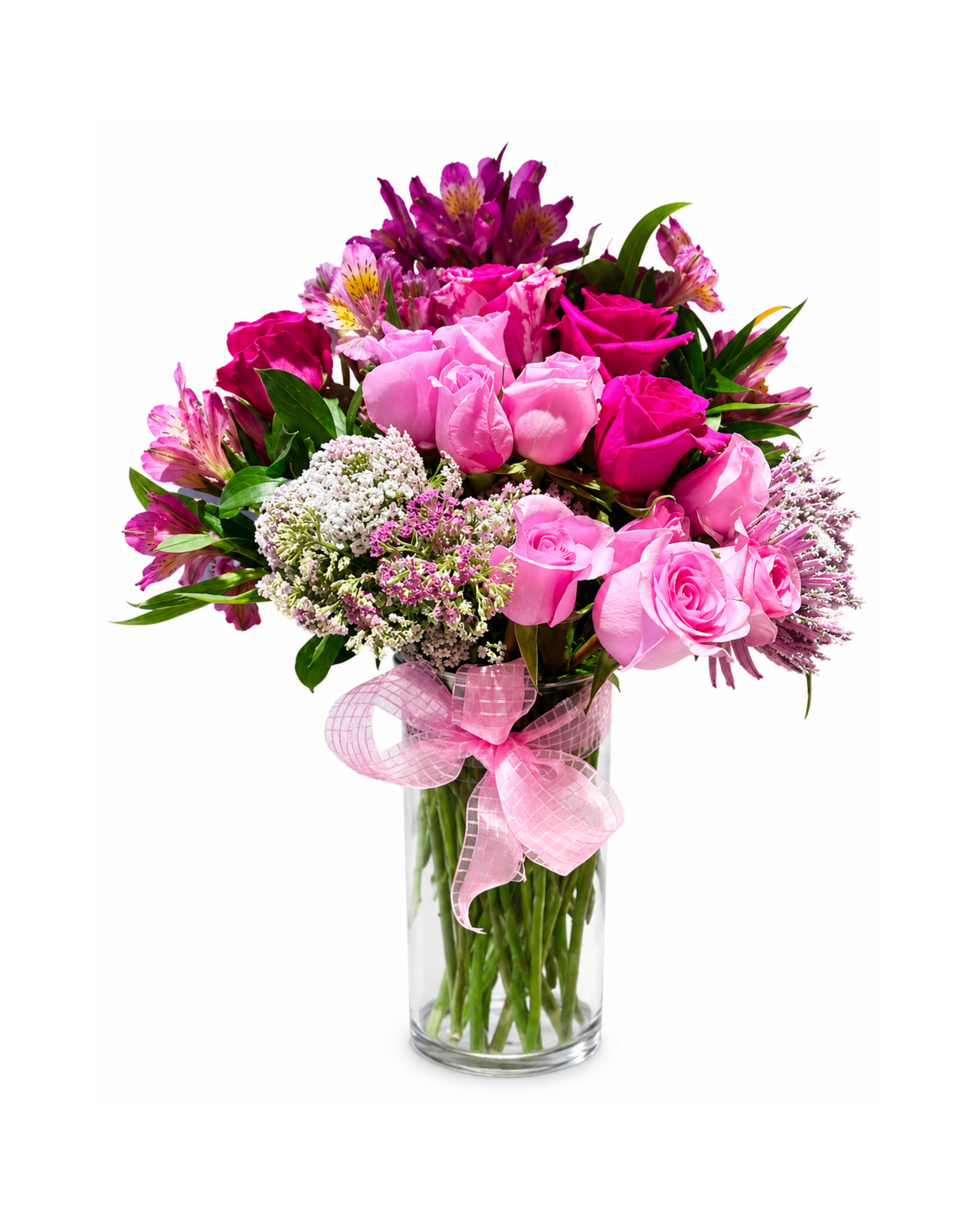 Bouquet of pink flowers in a glass vase with a pink ribbon on a white background