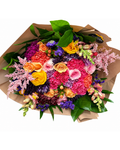 Colorful bouquet of flowers wrapped in brown paper on a white background