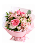 Bouquet of pink and white flowers wrapped in pink paper with a green tag on a white background