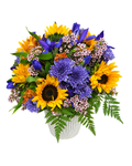 Bouquet of sunflowers, purple flowers, and greenery in a white basket on a white background