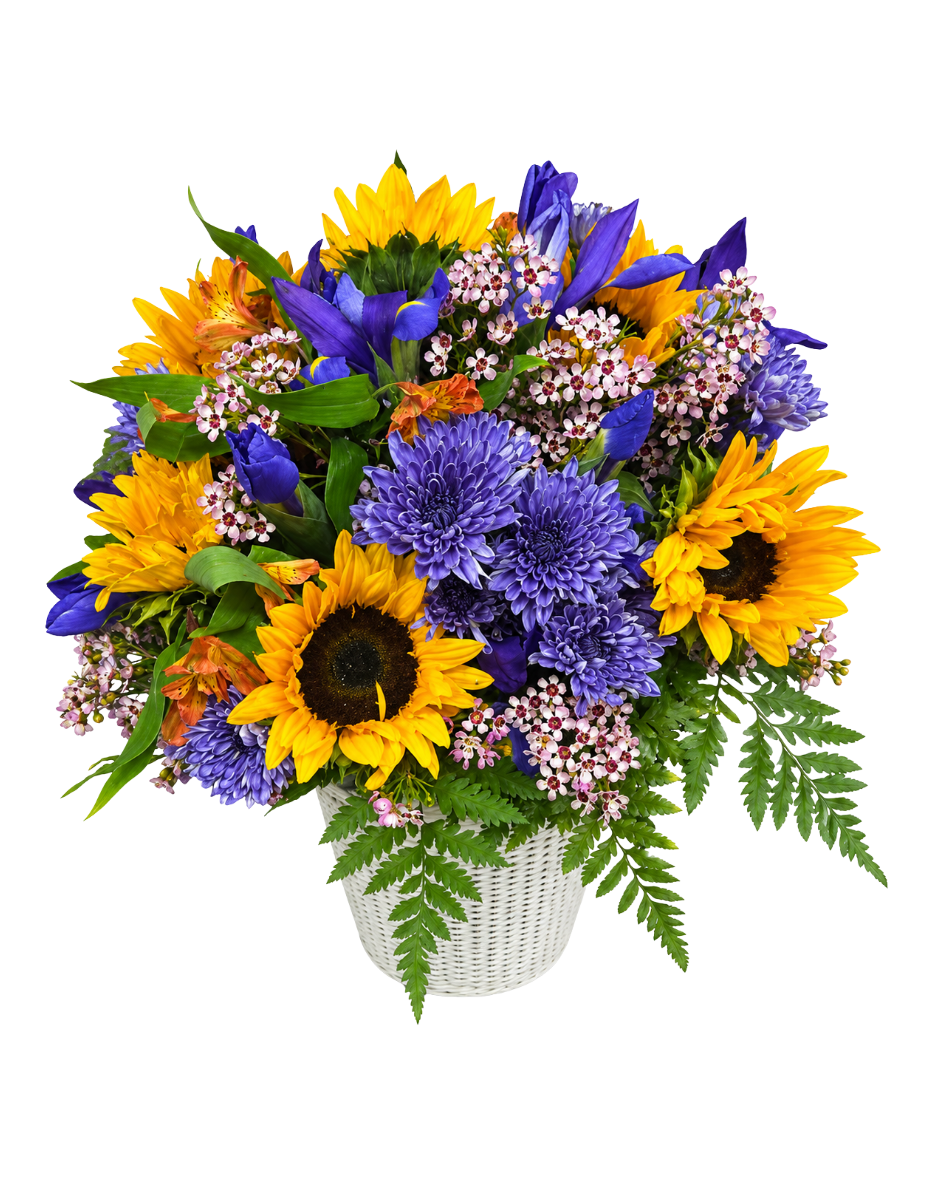 Bouquet of sunflowers, purple flowers, and greenery in a white basket on a white background