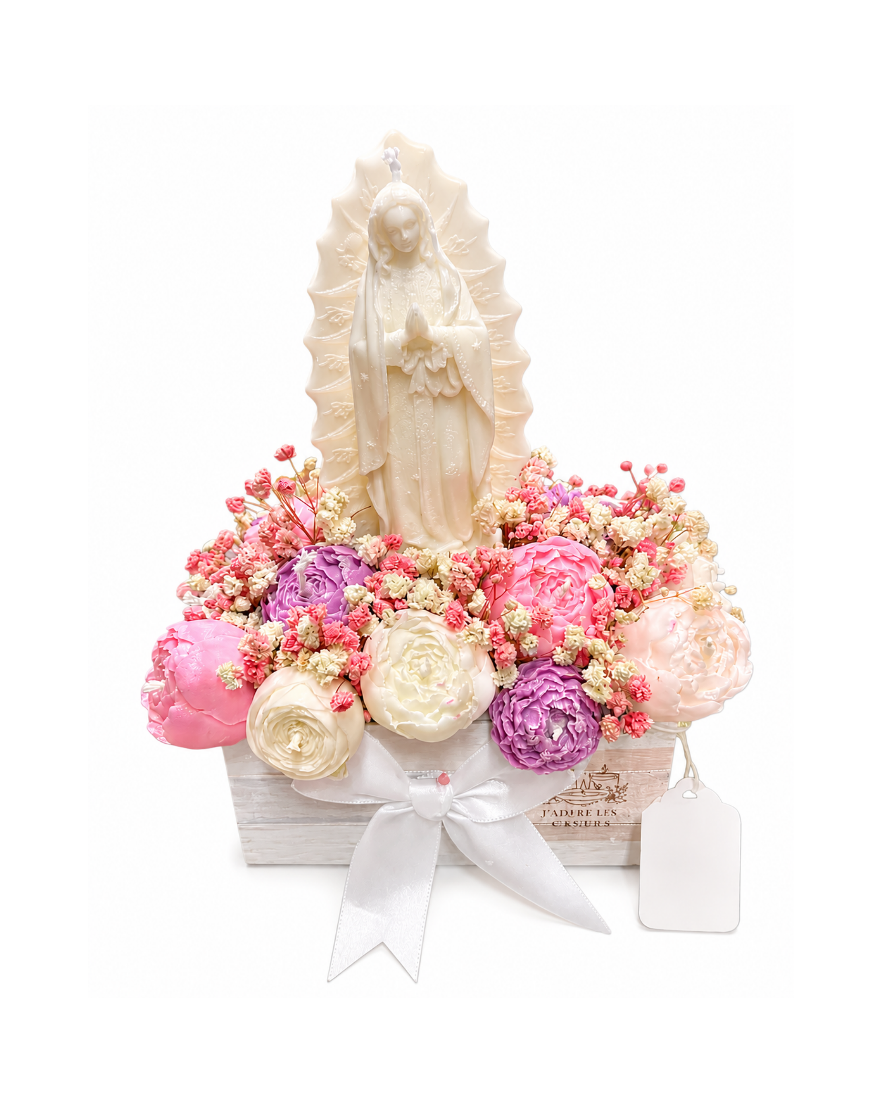 Statue of a religious figure surrounded by pink and white flowers on a white background