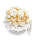 A round white floral arrangement featuring white roses, white orchids, and delicate cream filler flowers, presented in a white box with a ribbon bow on a white background.